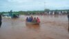 Passengers of a bus that was swept away by floodwaters are rescued by boat, near Garissa, Kenya, on April 9, 2024.