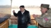 This picture taken on March 18, 2024, and released from North Korea's official Korean Central News Agency on March 19, 2024, shows North Korea's leader Kim Jong Un attending a rocket salvo firing drill, at an unconfirmed location in North Korea.