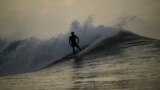 Tahitian-born surfer Kauli Vaast rides a wave in Teahupo'o, Tahiti, French Polynesia, Sunday, Jan. 13, 2024. (AP Photo/Daniel Cole)
