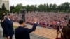 Chinese President Xi Jinping, center, accompanied by Serbian President Aleksandar Vucic, greets the people gathered outside the Palace of Serbia during a a welcome ceremony in Belgrade on May 8, 2024. (Serbia's Presidential Press Service via AFP)