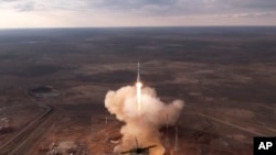 In this photo taken from video released by Roscosmos, the rocket transporting a Soyuz spacecraft carrying American Tracy Dyson, Russian Oleg Novitsky and Belarusian Marina Vasilevskaya to the International Space Station lifts off from Baikonur, Kazakhstan, on March 23, 2024.