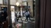 บริกรชายหญิงในชุดทำงานสะท้อนในกระจกคาเฟ่ ระหว่างที่พวกเขาเข้าแข่งขัน cafes' race ที่กรุงปารีส ฝรั่งเศส เมื่อ 24 มี.ค. 2024 (เอเอฟพี)
