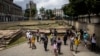 FILE - People visit the archeological site Valongo Wharf, the main port of entry for enslaved Africans to Brazil and the Americas, in Rio de Janeiro, Brazil, Nov. 13, 2021. Brazil received more slaves from Africa than any other place. 