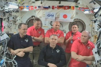 NASA astronaut Serena Auñon-Chancellor (right) with her fellow crew members of the International Space Station (ISS), on a live in-flight call to UNISPACE+50 on 20 June 2018.