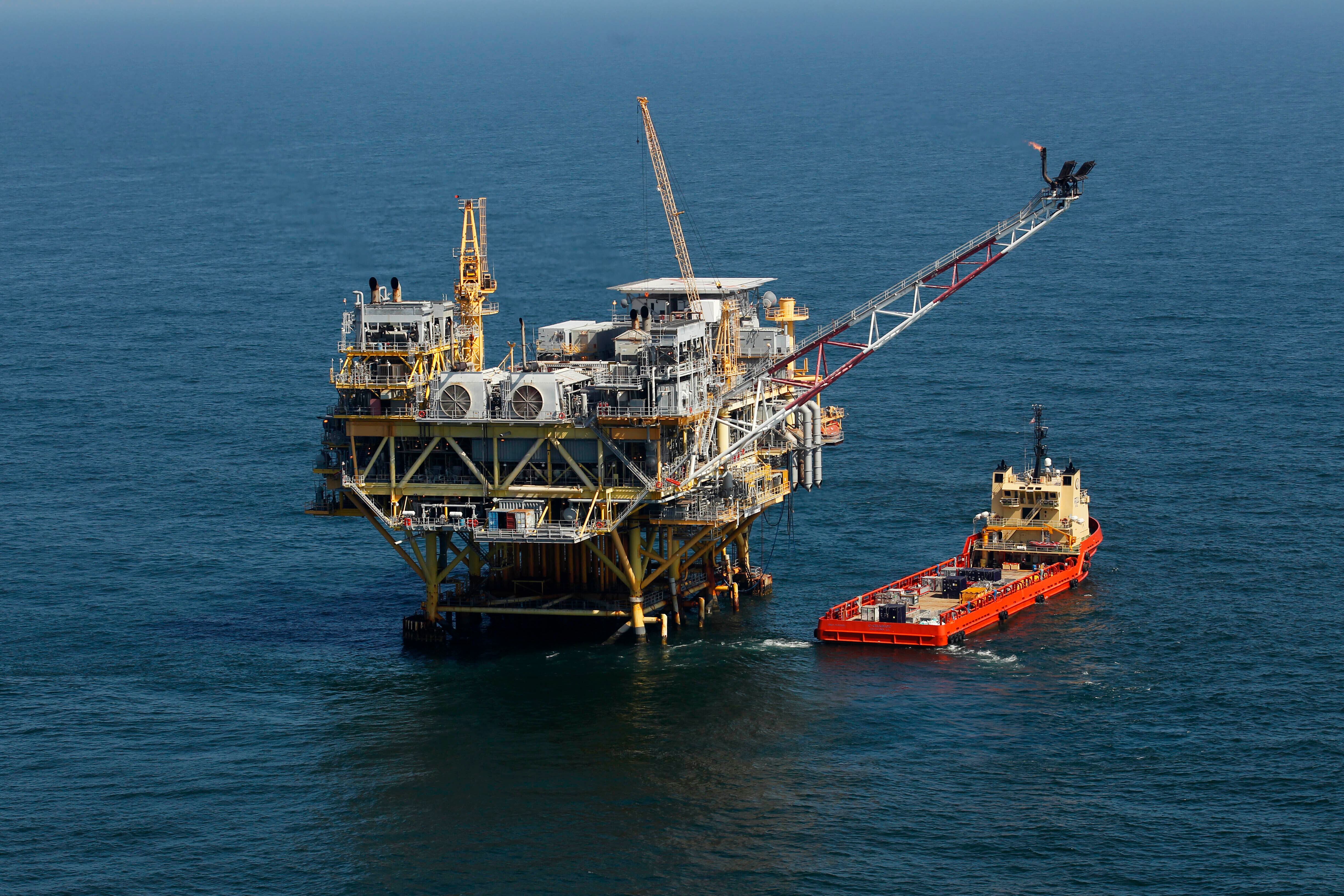 FILE - This Sunday, April 10, 2011 picture shows a rig and supply vessel in the Gulf of...