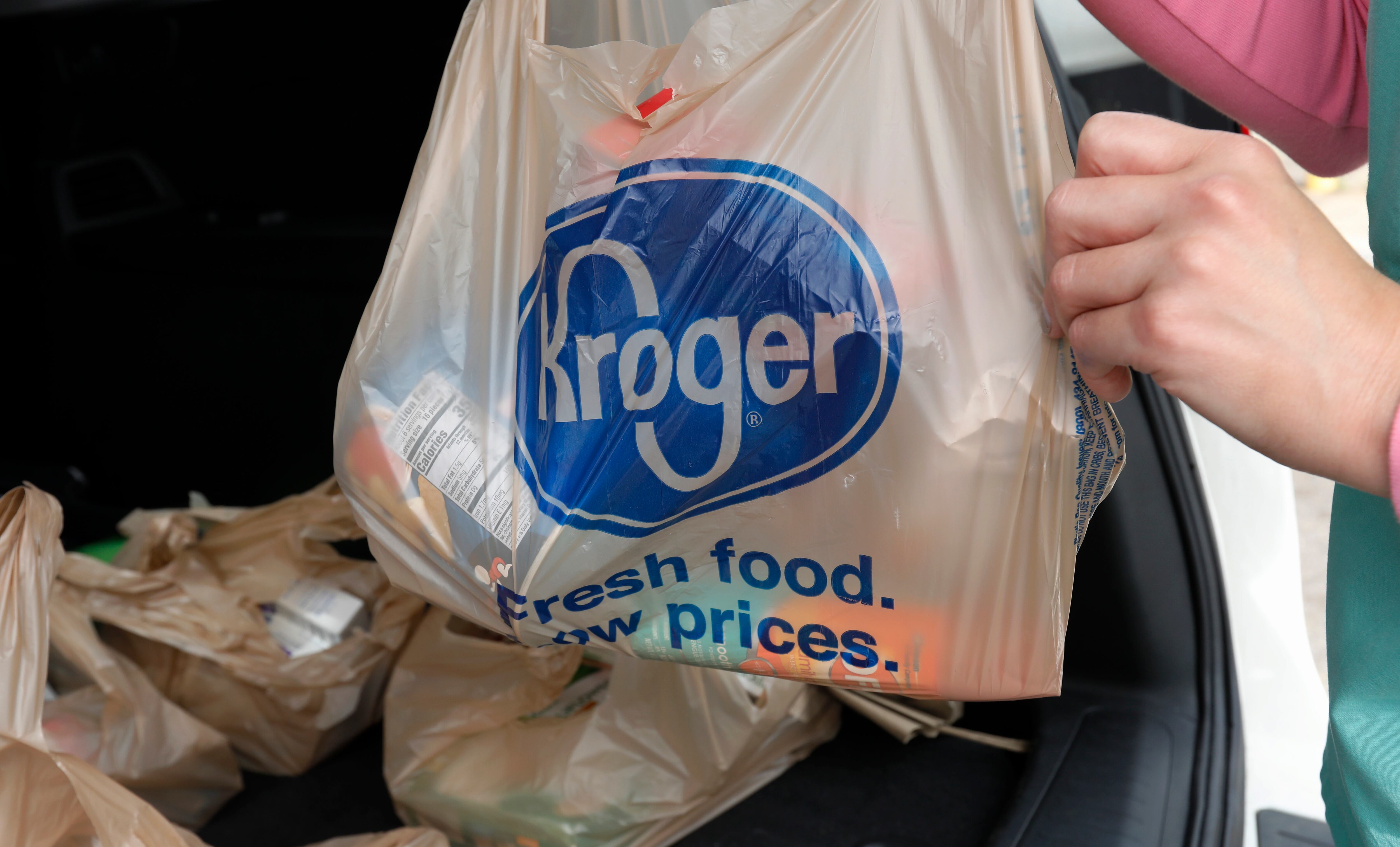 FILE - A customer removes her purchases at a Kroger grocery store in Flowood, Miss.,...