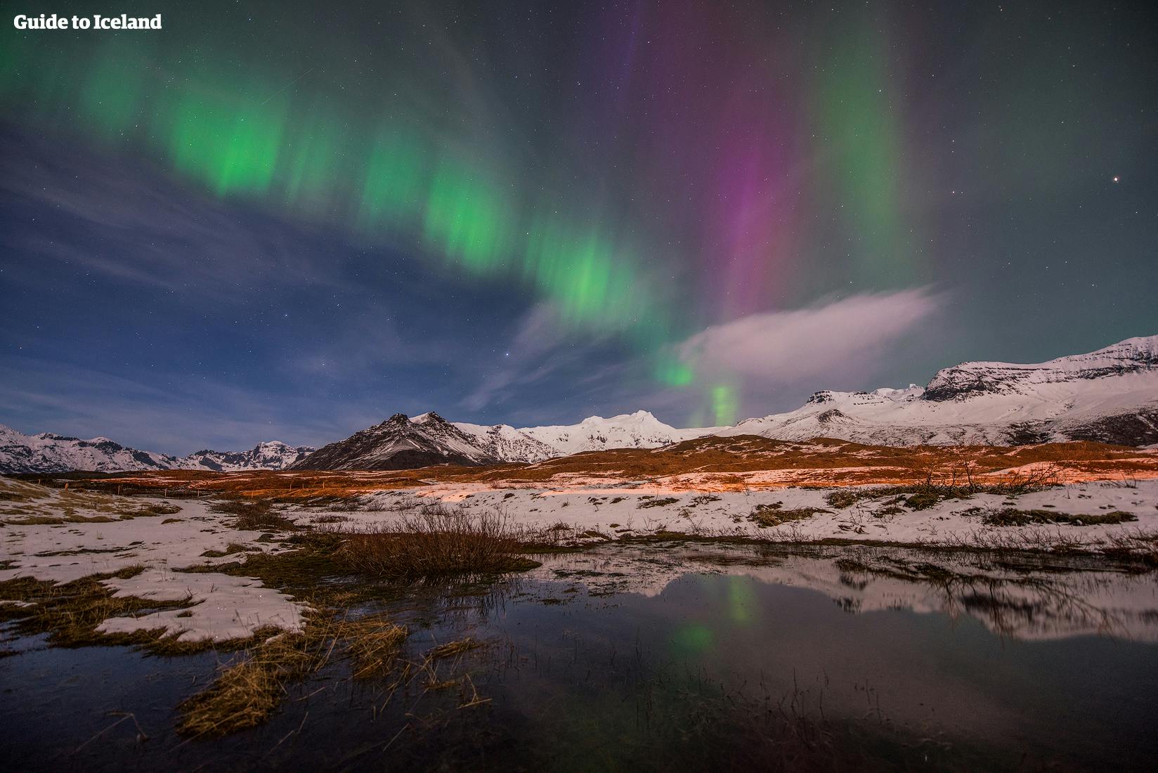 The northern lights dancing in the sky above Iceland in winter.
