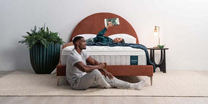 a couple hanging out on a Leesa mattress in a bedroom
