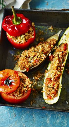 stuffed zucchini boats with rice and tomatoes on a baking sheet, ready to be eaten