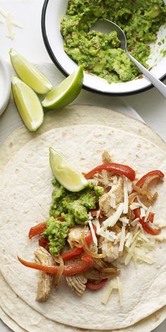 two tortillas with chicken, peppers and guacamole on the side