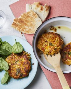 A frying pan and plate containing three fried risotto cakes with pitta bread and salad alongside. Risotto Cakes, Pasta Shapes, Fritters, Warm Salad