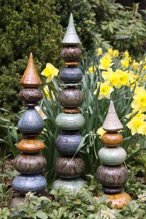 I like the pieces, not sure I like the tops.  Posted on paulabarryceramics.com Garden Totems