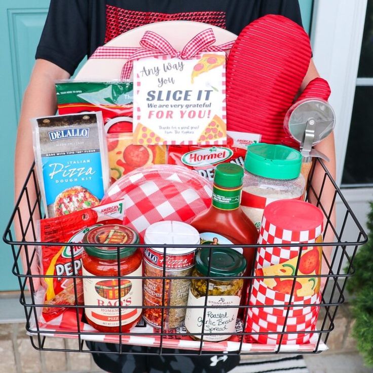a person holding a basket full of food and condiments in front of a door