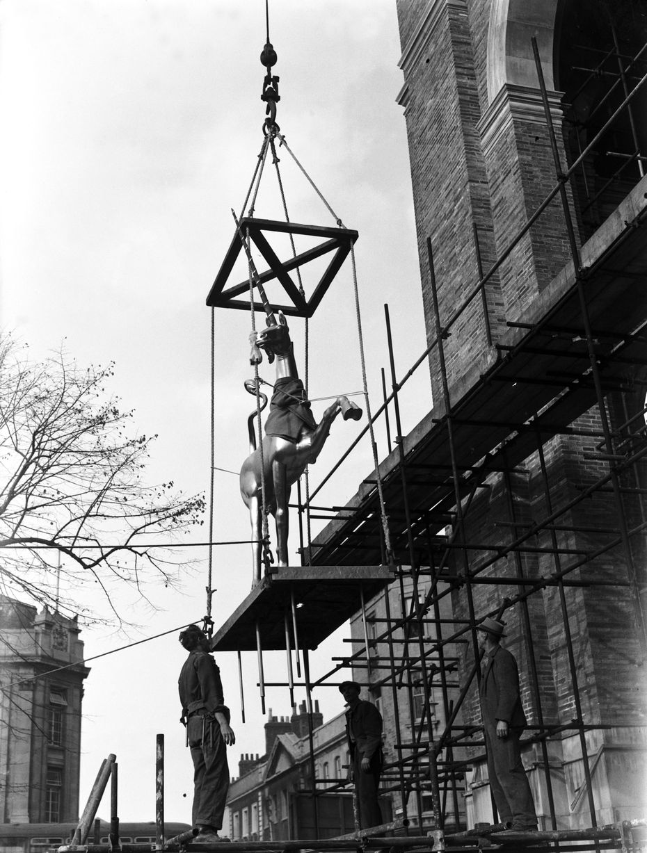 One of twin gilded unicorns that adorn the roof of the City Hall, Bristol, being hoisted into place in October 1950