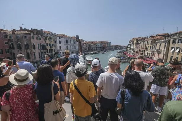 Tourists flock to the Rialto Bridge in Venice (Photo by Stefano Mazzola/Getty Images)
