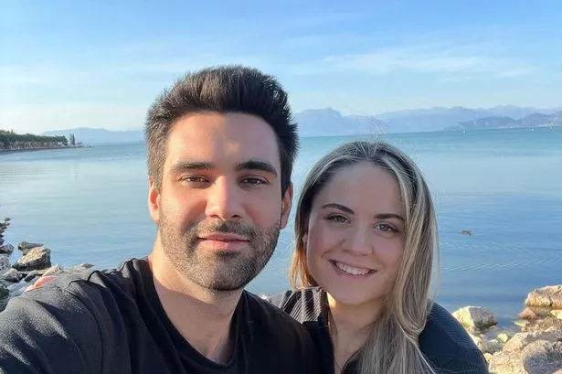 Harriet and her partner pose for a selfie in front of Lake Garda