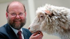 Prof Sir Ian Wilmut with his creation, Dolly the cloned sheep in 1996