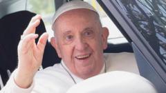 Pope Francis waves from a car as he leaves Rome's Gemelli hospital in Rome, Italy, April 1