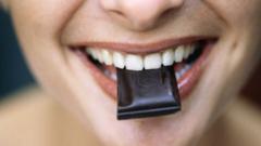 Woman's mouth with dark chocolate in it