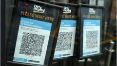 Track and trace QR codes are displayed outside a pub, in Manchester, north west England in October, 2020