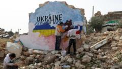 mural amid the destruction, depicting the colours of the Russian and Ukrainian flags, painted by Syrian artists to protest against Russia's military operation in Ukraine, in the rebel-held town of Binnish in Syria's northwestern Idlib province on February 24, 2022