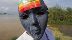 Person with a mask on and a rainbow sticker