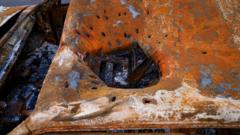 Shrapnel damage in a car roof in Kharkiv (Joel Gunter/BBC)