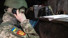 Ukrainian officer Vlad using an old wind-up phone in Eastern Ukraine