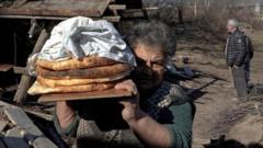 Local resident Zina Fatyan carries freshly baked bread in divided Taghavard village in Nagorno-Karabakh region on 15 January 2021