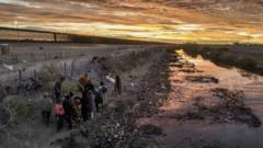 Migrants cross the Rio Grande