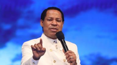 Chris Oyakhilome in a white suit