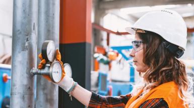 Technician inspecting pressure gauge