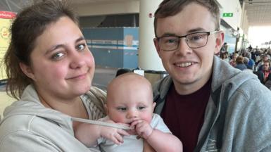 Elizabeth and James Devine stranded at Dubai World Central Airport with their son Thomas