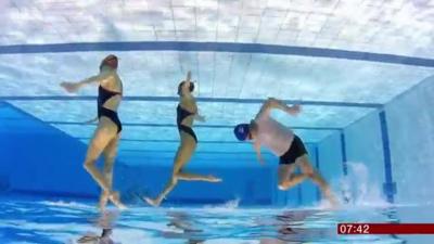 Mike Bushell trying out sychronised swimming with two members of Team GB for BBC Breakfast