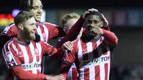 Lincoln players celebrate victory against Cambridge