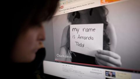 A woman views the YouTube video of Amanda Todd on an office monitor in Washington, DC on October 16, 2012
