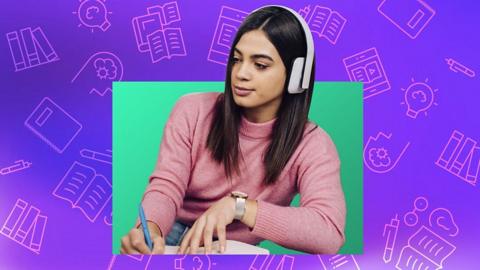 A young student listening to a podcast and making notes.