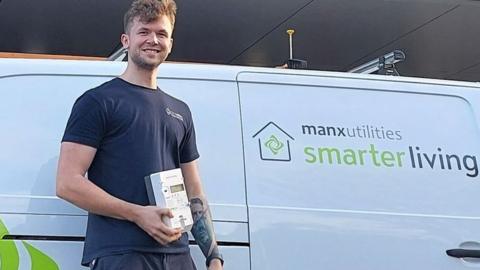 Man holding smart meter in front of MU van