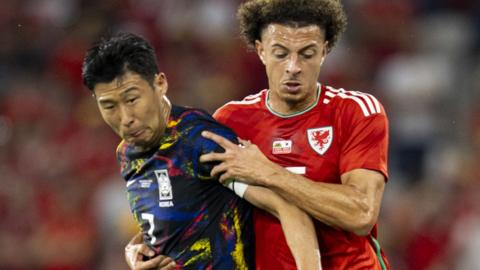 South Korea captain Son Heung-min (left) challenges Ethan Ampadu of Wales