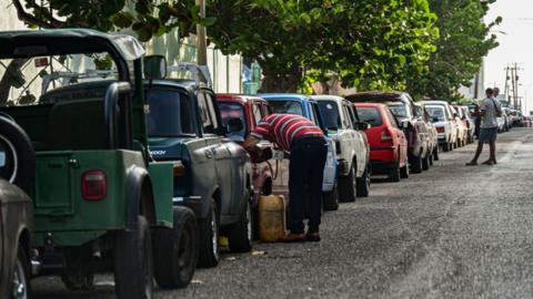 Drivers queue to get fuel near a gas station in Havana