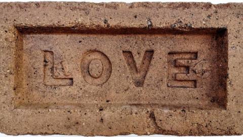 Brick with LOVE stamped on it