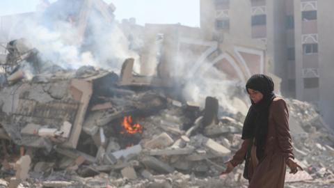 A Palestinian woman reacts after her apartment was destroyed in Hamad City, in the southern Gaza Strip (13 March 2024)