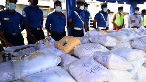 Sri Lanka Navy personnel shows a haul of heroin seized from a fishing vessel off the islands southern waters in Colombo on 25 January 2022