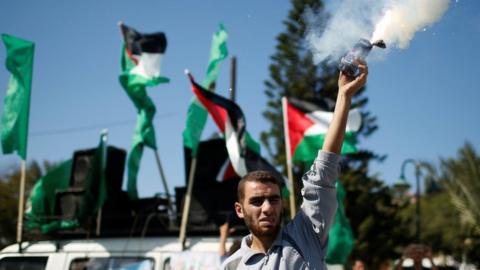 A Palestinian man releases fireworks during celebrations after Hamas said it had reached a deal with Palestinian rival Fatah, in Gaza City, 12 October 2017