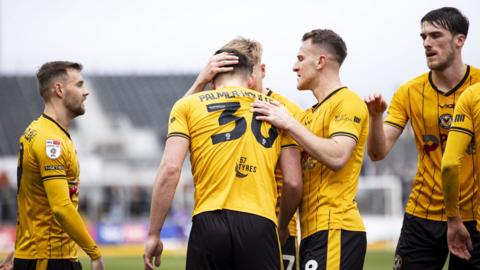 Newport County players celebrate with Seb Palmer-Houlden