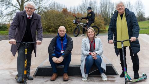 BMX freestyle rider Chester Turner at Wombridge skate park with left to right, ward member councillor Stephen Reynolds, play officer Richard Foden, cabinet member for climate change, green spaces, natural and historic environment and cultural services, Carolyn Healy and ward member councillor Hilda Rhodes.
