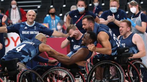 Great Britain's men's wheelchair basketball players celebrate winning the bronze medal against Spain