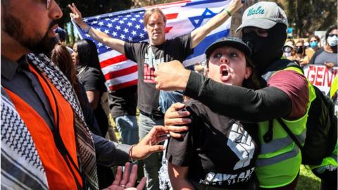 Protesters in support of Palestinians in Gaza and pro-Israel counter-protesters scuffle during demonstrations at the University of California Los Angeles (UCLA) in Los Angeles, California