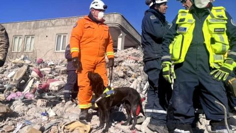 Kyle and Delta on search duty on a rubble pile