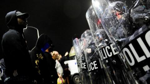 Police faceoff off with a protester